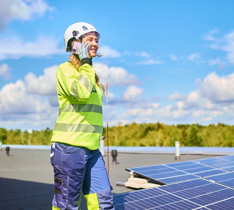 worker-on-roof-smiling.jpg